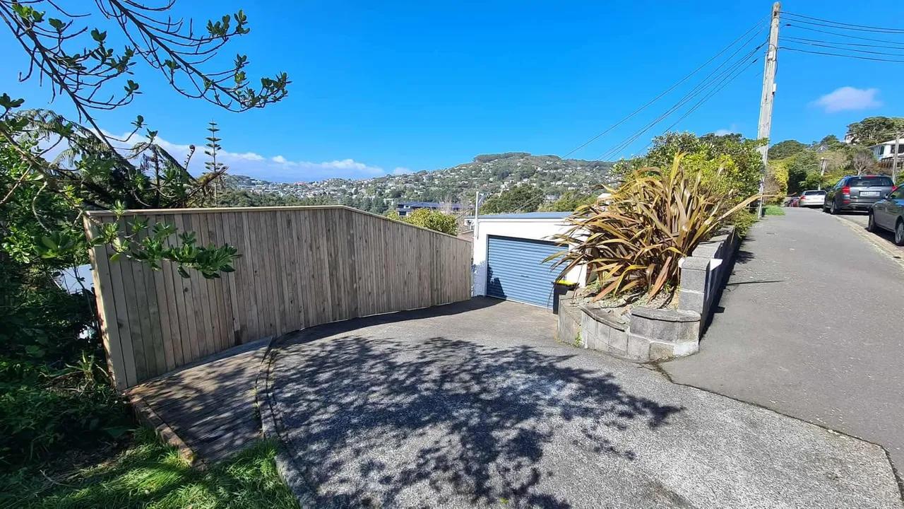 Timber sliding driveway gate with Wellington hillside views