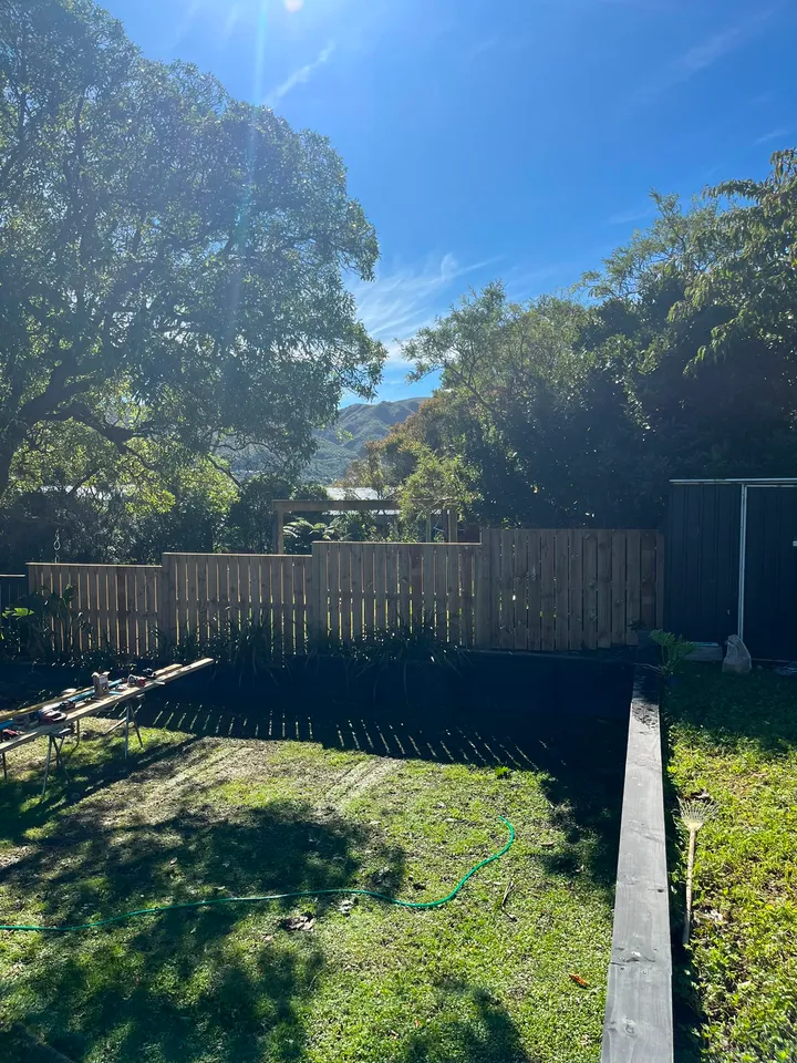 Timber retaining wall with integrated fencing on a Wellington slope